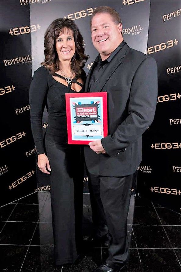 Dr. James E. Murphy with award